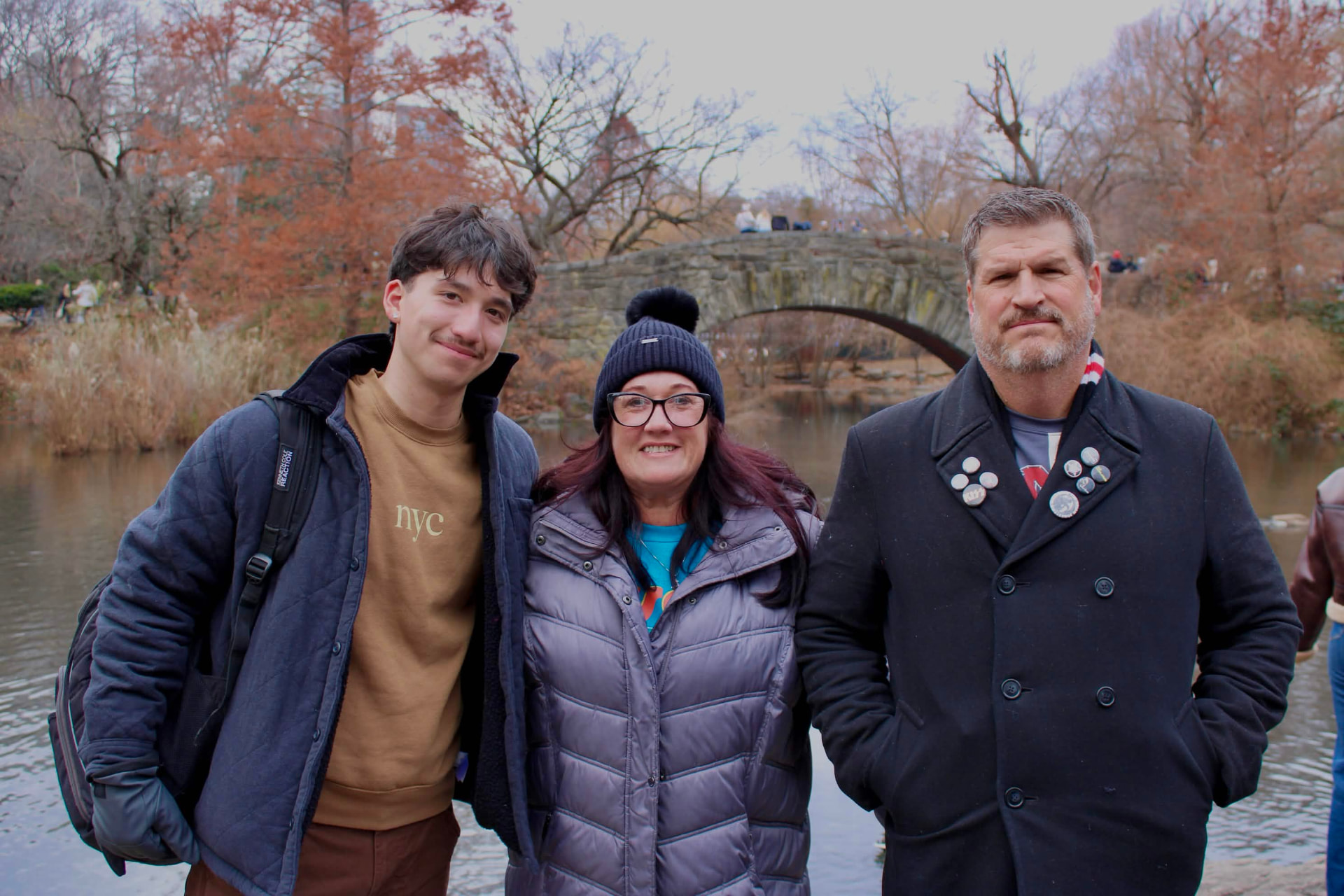 Family portrait in front of a stone bridge in the park