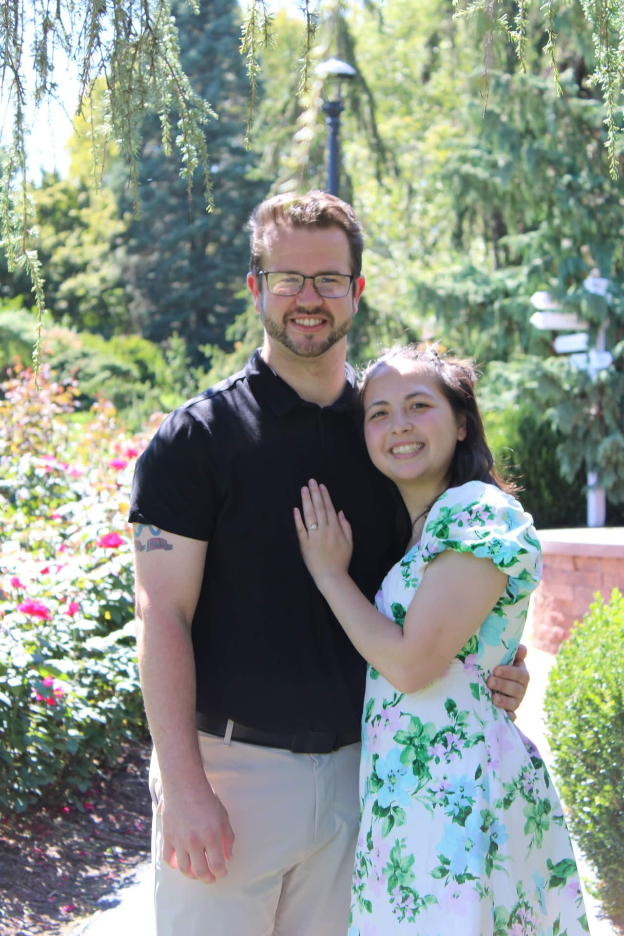 Engaged couple in a rose garden